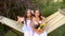 Two sisters swinging on a hammock