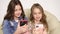 Two sisters take selfies at home, smiling friends taking a self shot with phone