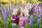 Two sisters and their mother in lupine field