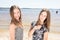 Two sisters twins in the summer beach vacation beauty teenager girls