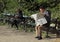 Two are sitting on benches in public park of Copenhagen