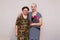 Two sixty year old smiling women with flowers