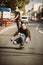 Two skateboarders ride a skateboard slope in the city street