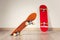 Two skateboards yellow and red on a wooden floor background.