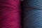 Two skeins of knitted yarn. Grey and burgundy knitting threads for bags and home design. Two colour textured background