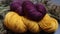 two skeins of yarn sitting on top of a pile of dried plants and twigs on a table top with dried flowers in the background