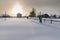 Two skiers skiing on the snow-covered yard. Village Visim, Russia