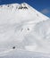 Two skiers and snowy off-piste slope with traces of skis, snowboards and avalanches.