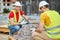 Two skilled workers in cotton gloves selecting external paving materials