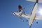 Two skydivers exit an airplane