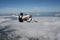 Two skydivers in a sit position while in freefall