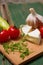 Two slices of camembert and vegetable on chopping board