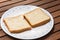 Two slices of plain wholemeal bread on plate