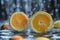 Two slices of Valencia oranges are splashing in liquid