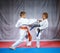 Two small athletes are training paired exercises karate
