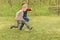 Two small boys running across a field