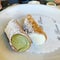 Two small cannoli, Sicilian desert, cakes with ricotta cream, pistachio cream, crunchy cookies with cream, Italian dessert