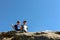 Two small children, brothers boys standing on one rocky peak, a mountain of Carpathian mountains, happy children, children on a