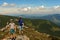 Two small children, brothers boys standing on one rocky peak, a mountain of Carpathian mountains, happy children, children on a