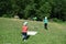 Two small children hunt butterflies