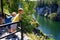 Two small childrens look through a handrail at a canyon