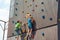 Two small climbers conquer the summit of an artificial mountain in a sports amusement park