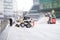 Two small excavators - loaders with buckets remove snow from a road on a street