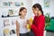 Two small school girl friends standing at school, talking.