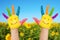 Two smiley hands in sunny summer\'s day.