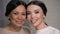 Two smiling asian women looking at camera, mother and daughter faces closeup