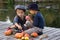 Two smiling boys paint small apples