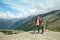 Two smiling boys stand on top of rock