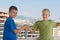 Two smiling boys in T-shirts are shake hands