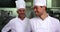 Two smiling chefs giving ok sign to camera