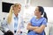 Two smiling, female dentist sitting face to face