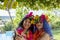 Two smiling female friends dressed in Hawaiian costumes take a selfie