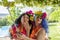 Two smiling female friends dressed in Hawaiian costumes take a selfie