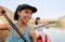 Two smiling friends kayaking on a lake together during summer break. Smiling and happy playful women bonding outside in