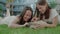 Two Smiling Girls Plays With Puppy Outside.