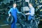 Two smiling males colleagues working with motorcycle tires