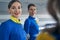 Two smiling pleased young stewardesses looking ahead