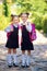 Two Smiling student girl wearing school backpack. Portrait of happy Caucasian young girl outside the primary school