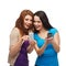 Two smiling teenagers with smartphones