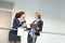 Two smiling young businesswomen chatting