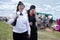 Two smiling young women in police uniform walk along the road