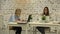 Two smilling businesswomen working on laptop at office