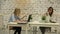 Two smilling businesswomen working on laptop at office