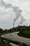 Two Smoke Stacks letting out steam on a gloomy day in Wisconsin