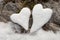 Two snow hearts on rock