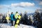 Two snowboarders posing at ski resort. Riders friends carrying their snowboards through forest for backcountry freeride